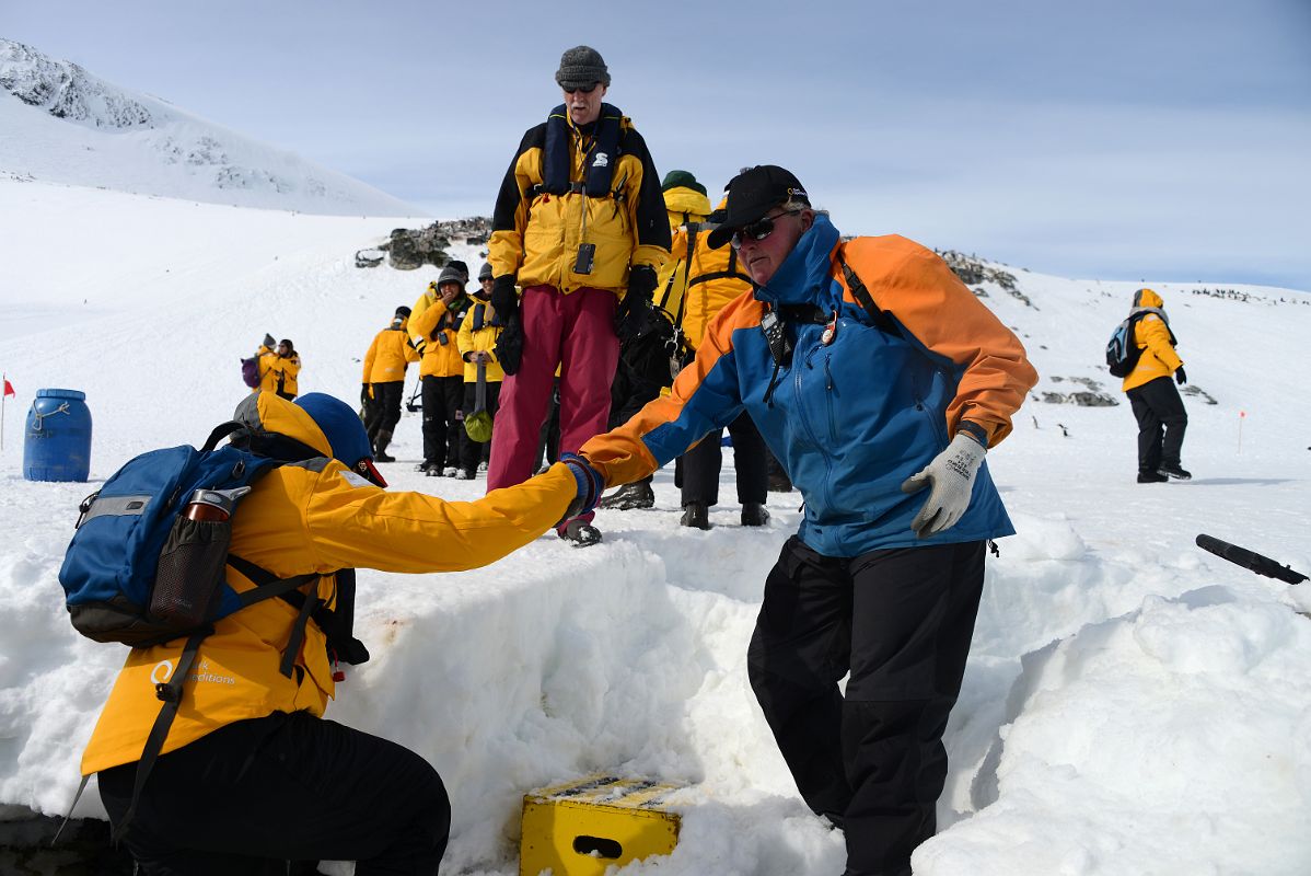 20C Getting A Helping Hand To Land On Cuverville Island From Zodiac On Quark Expeditions Antarctica Cruise